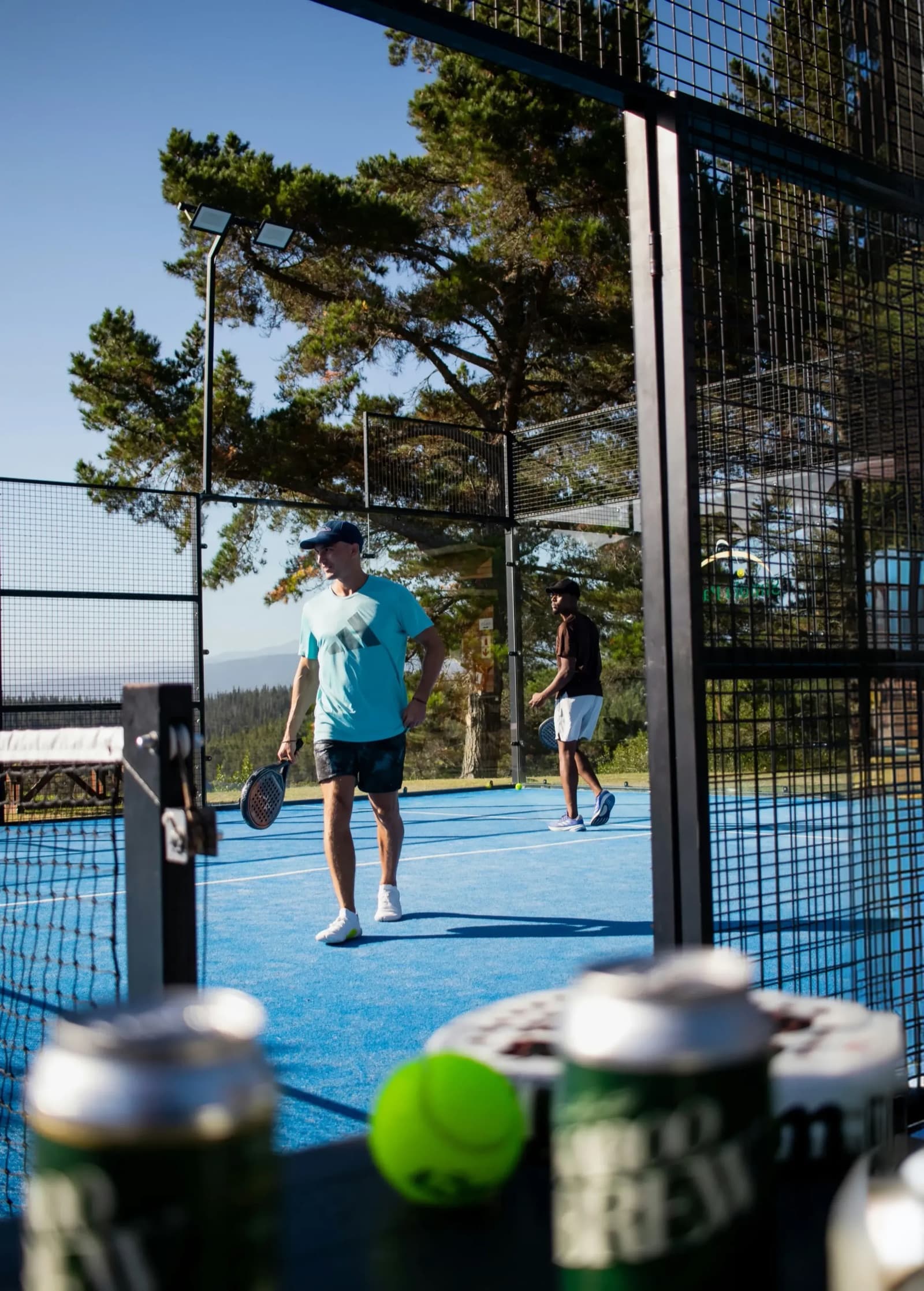 Padel players mid-rally on court